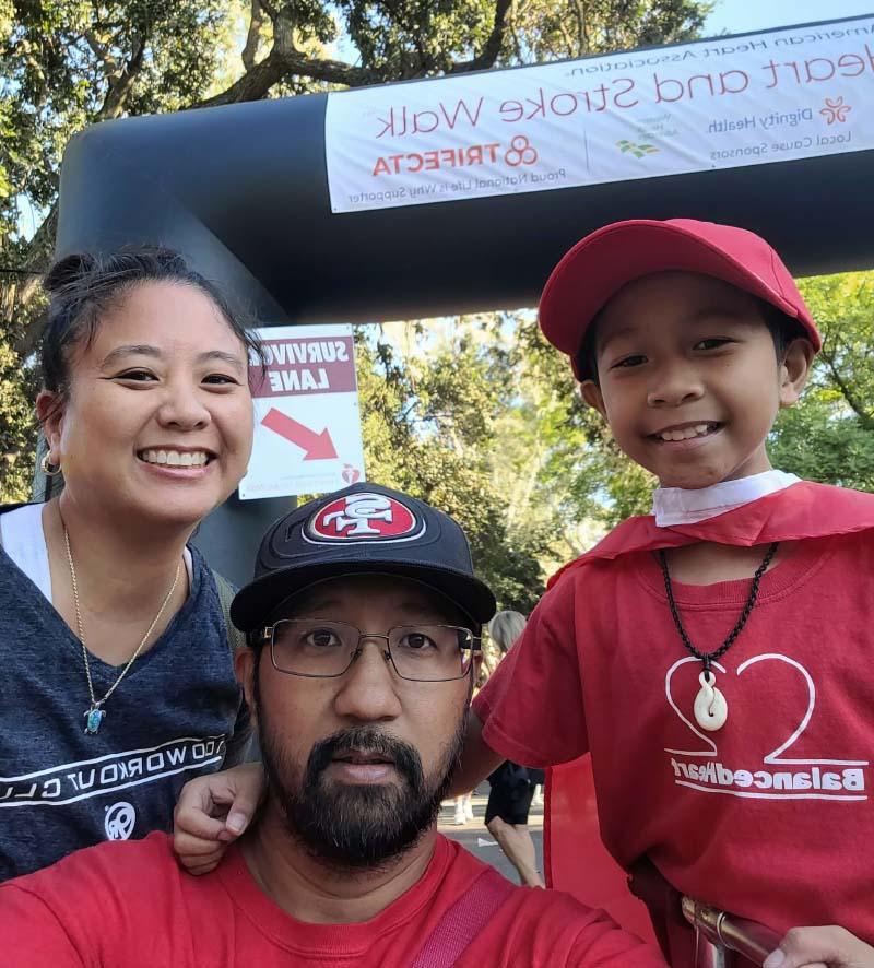 Luke Domingo (left) with his parents, Geody and Mia, at an American Heart Association Heart and Stroke Walk. (Photo courtesy of Mia Domingo)